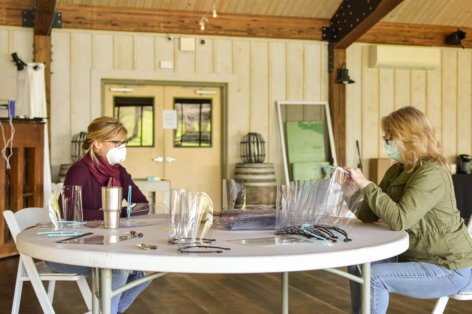 Volunteers from the Hudson Valley assembling face shields at Red Maple Vineyard